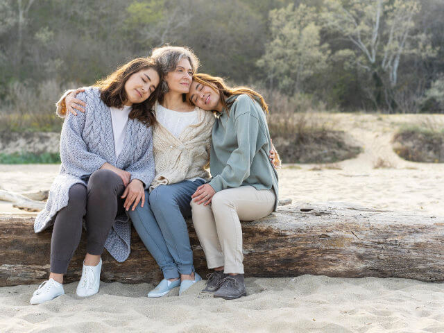 mother-spending-time-beach-with-her-two-daughters